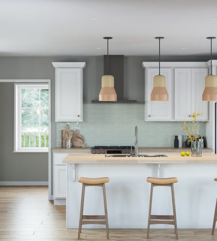 A modern kitchen featuring white cabinets and warm wooden floors, creating a bright and inviting atmosphere.