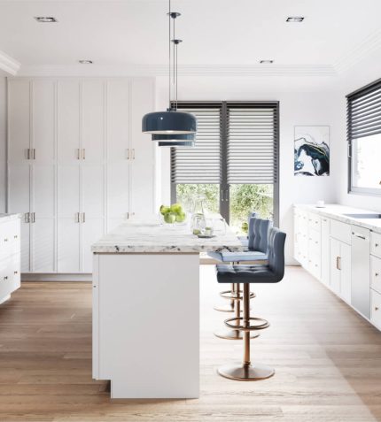 A modern kitchen featuring white cabinets and warm wooden floors, creating a bright and inviting atmosphere.