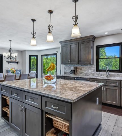 A modern kitchen featuring granite countertops and dark wood cabinets, showcasing a sleek and elegant design.