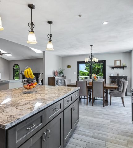 A modern kitchen featuring granite countertops and dark wood cabinets, showcasing a sleek and elegant design.