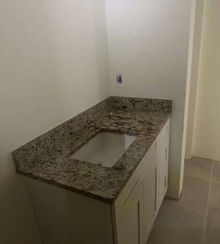 Bathroom featuring elegant granite countertops and a modern sink.